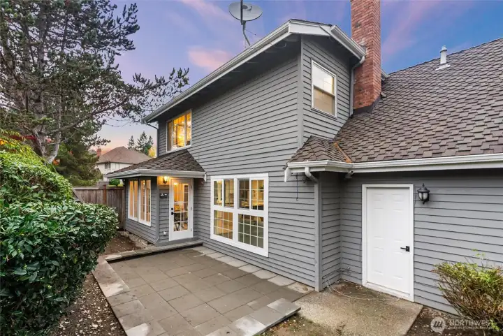 Rear exterior showcasing mature landscaping and privacy.