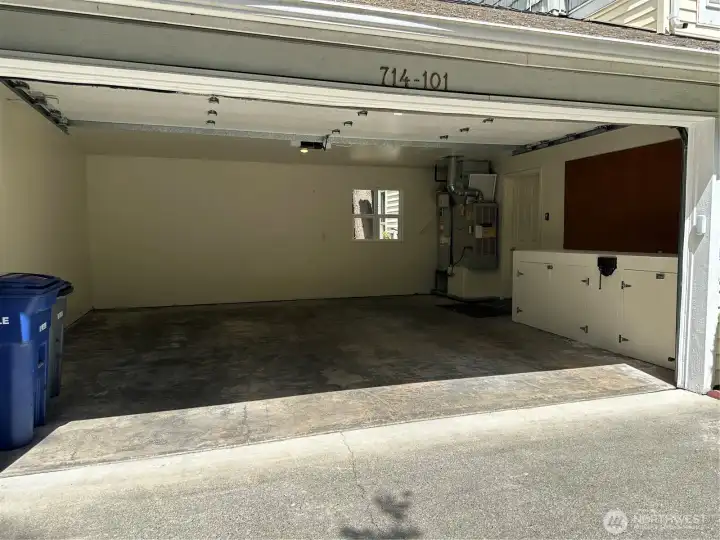 Large two car garage with workbench and storage. Large two car garage with workbench and storage.
