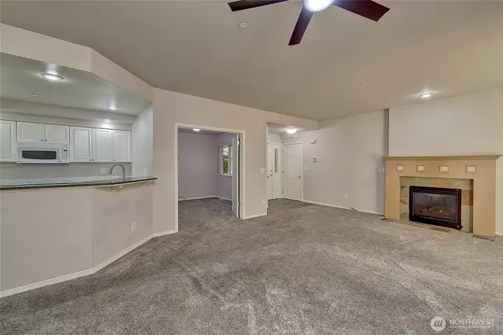 Open floor concept featuring a large living/dining room with a gas fireplace and a bonus room with no closet.