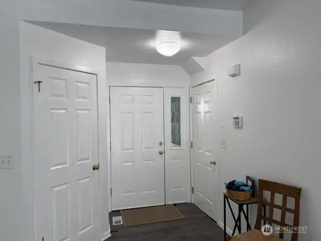 Entry with Coat Closet on Left and Garage Door Entry on Right. Entry with Coat Closet on Left and Garage Door Entry on Right.