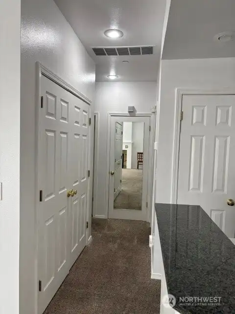 Hallway with utility on left. Hallway with utility on left.