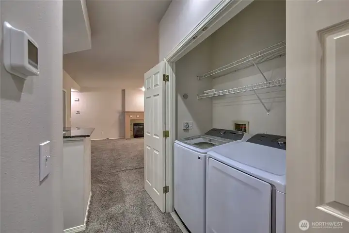 In unit laundry room with newer washer and dryer.