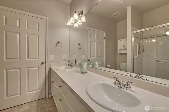 Another view of primary bath with large custom fit mirrors.