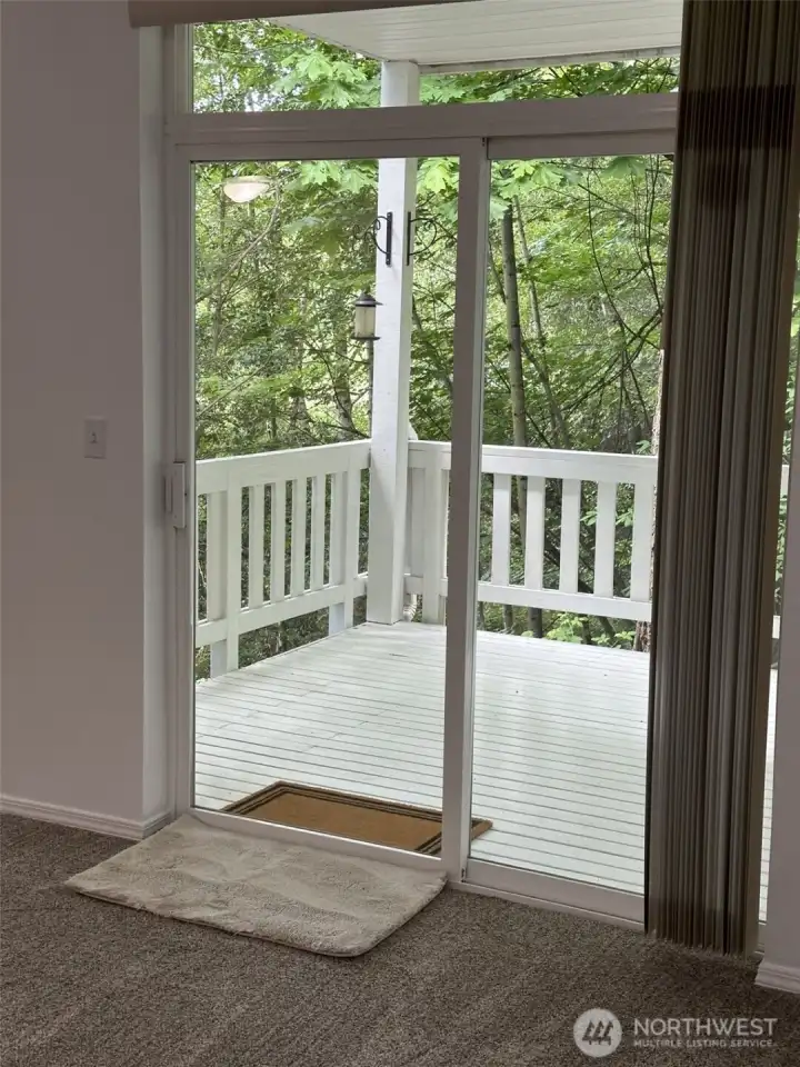 View from the dining room of the spacious covered deck with lots of privacy and beautiful sunsets. View from the dining room of the spacious covered deck with lots of privacy and beautiful sunsets.