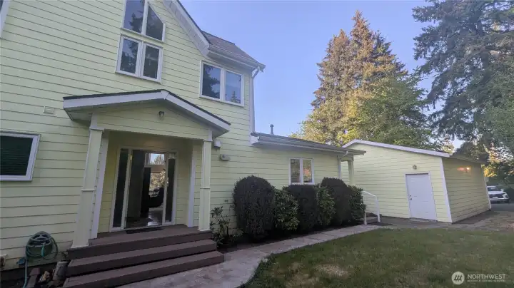 Back of home and backdoor, backyard and garage.