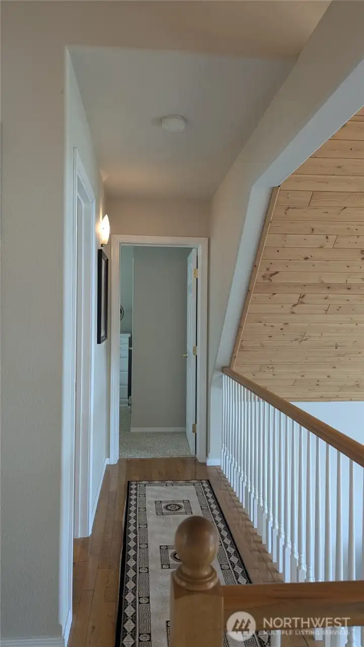 Hallway to two bedrooms and a bathroom.