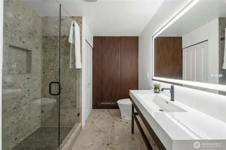 Main bath with tiled shower and smart toilet and mirriw Main bath with tiled shower and smart toilet and mirriw
