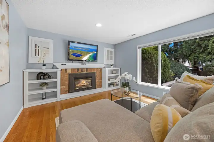 Family room off of kitchen features gas fireplace.