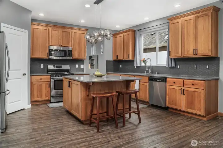 The heart of this home has been thoughtfully reimagined with gleaming quartz countertops, stainless steel appliances, and a generous center island perfect for gathering. The heart of this home has been thoughtfully reimagined with gleaming quartz countertops, stainless steel appliances, and a generous center island perfect for gathering.