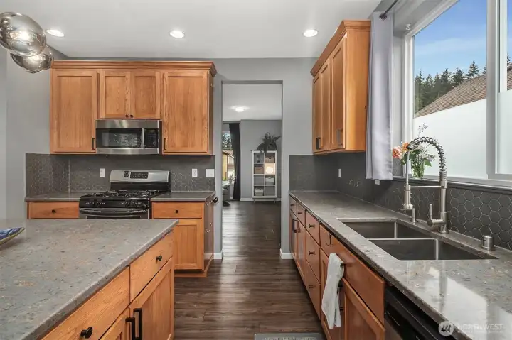 Kitchen features updated backsplash, quartz countertops, stainless steel appliances, and a generous center island. Kitchen features updated backsplash, quartz countertops, stainless steel appliances, and a generous center island.