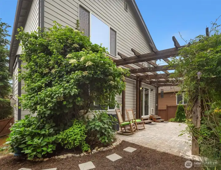 Lush landscaping and custom pergola. Lush landscaping and custom pergola.