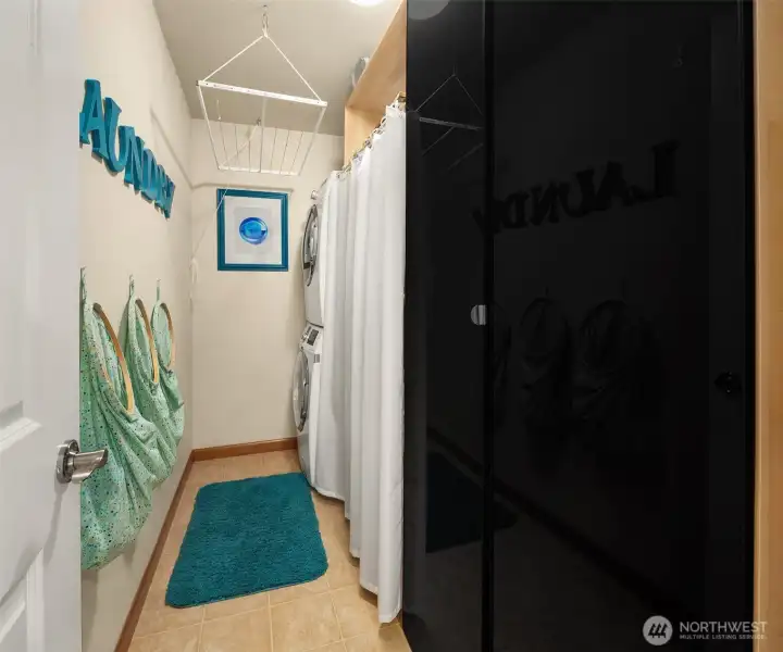 Laundry Room with full-sized stackable washer and dryer. Laundry Room with full-sized stackable washer and dryer.