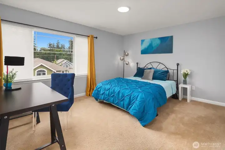 Spacious bedroom on upper level with natural lighting. Spacious bedroom on upper level with natural lighting.