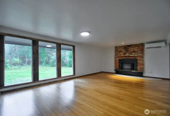 Spacious living room with beautifully refinished bamboo floors