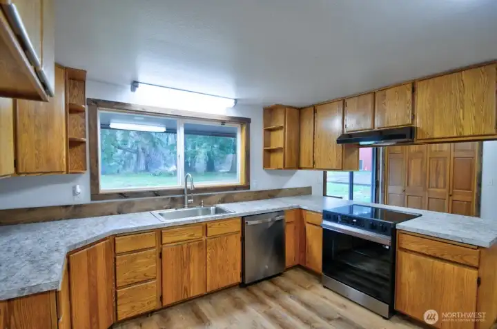 Country kitchen loaded with cabinet space & breakfast bar