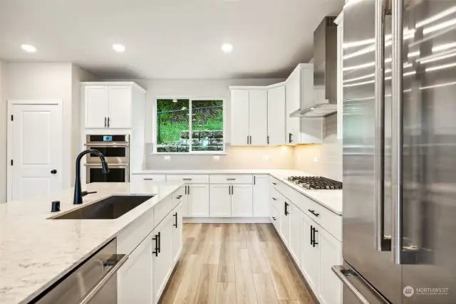 Kitchen features White painted Maple cabinetry with Matte Black fixtures and includes Jenn Air Stainless Appliances