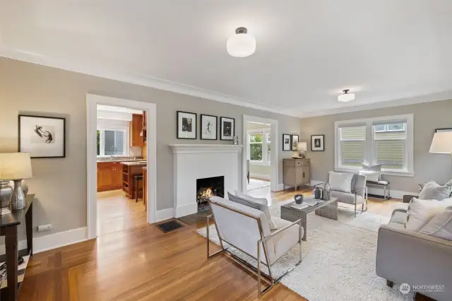 Living room with wood burning fireplace and original Mahogany floors