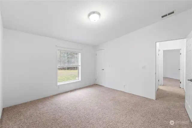 Second guest bedroom faces the rear of the home overlooking the backyard. A full guest bath down the hall on the left.