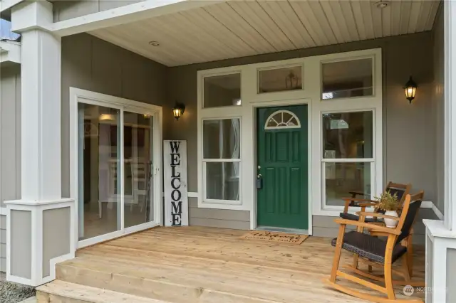 Covered country porch is welcoming. Large slider is easy access to the kitchen. Sip on morning coffee and take in the beautiful property.