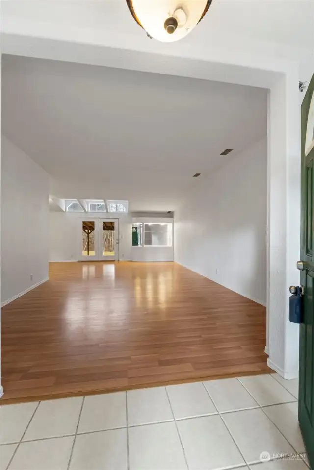 The front door welcomes you to this expansive living room. One the opposite end french doors open to the covered patio. A perfect home for entertaining year round!