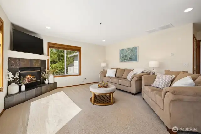 Large living room looking towards garage access on the right of photo w/extra storage under the stairwell to upstairs.