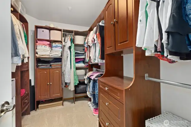 Primary suite walk-in closet w/custom built-ins.