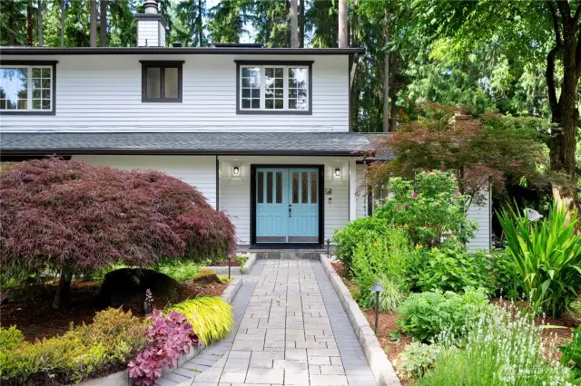 Flowers of various seasons are surrounding this house.