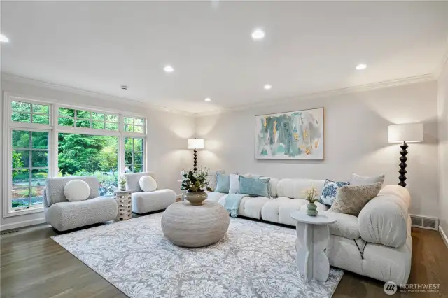 Living room has hardwood floor and a big window