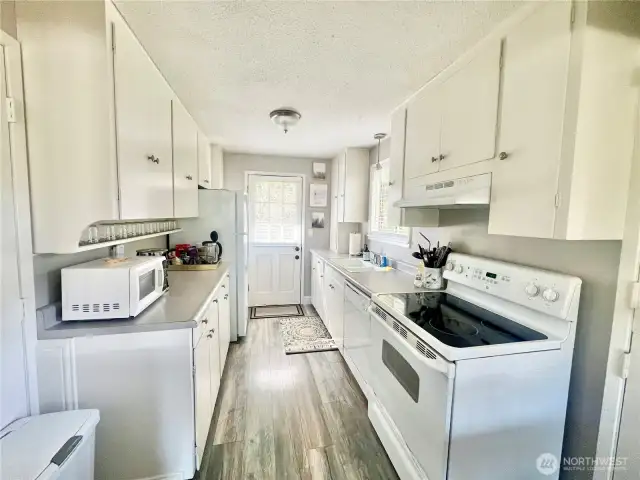 galley kitchen with a back door that exits into the