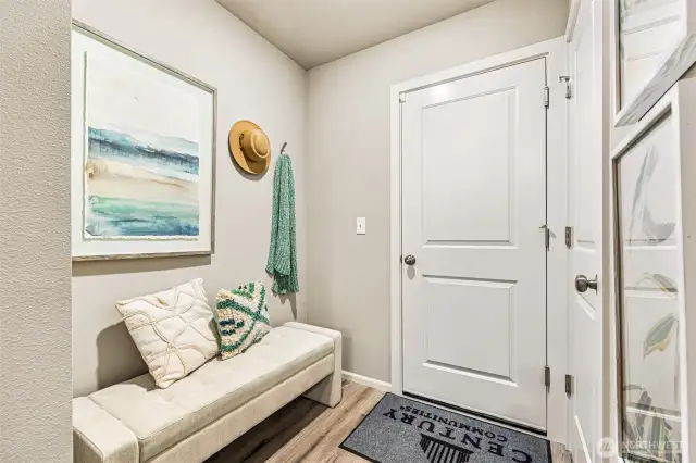 Mud room from garage enters into living room-Photos are from the Finley model home in prior community. Finishes, upgrades, and features will vary