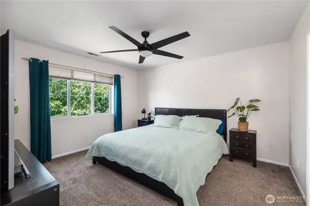 Primary bedroom with ceiling fan.