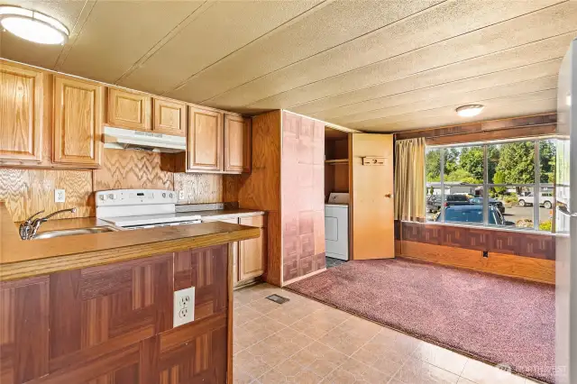 Kitchen flows into dining area.