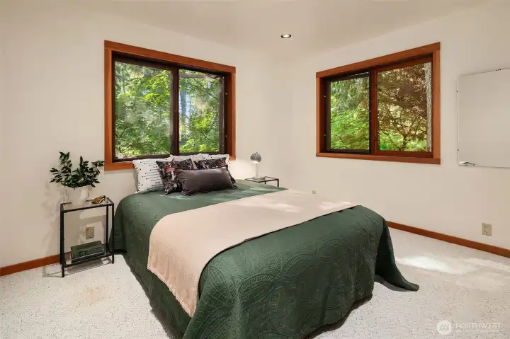 One of the two bedrooms on the second story with windows to the north and east.