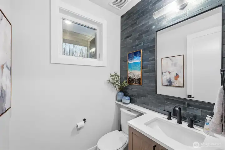 Main floor half bath is stylish and functional.