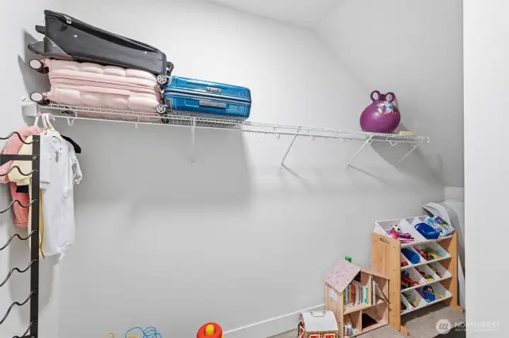 Main level coat closet is spacious and being used as a child's play area.