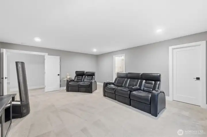 Currently used as a theatre, this could double as a second primary suite. The door on the right leads to the walk-in closet.