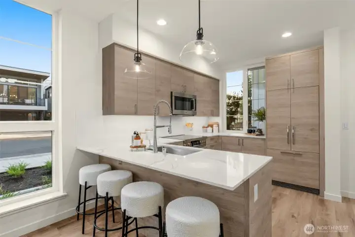Everything you need is at your fingertips in this U-shaped kitchen—seamlessly blending into the home's elevated vibe.
