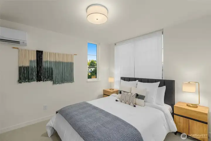 A bedroom that feels like a retreat. Plush carpet, layered lighting, and windows that invite in the perfect glow.