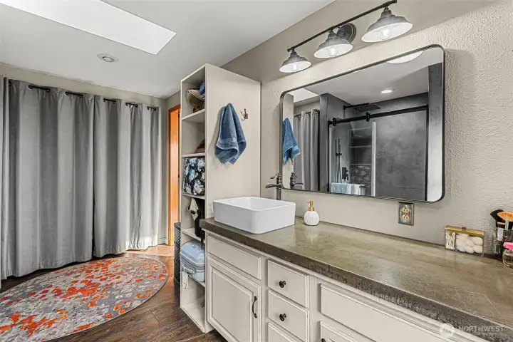 Walk in shower with tiles floors expansive vanity.