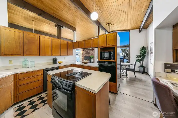 Kitchen is simple with plenty of counter space and areas for many to work together