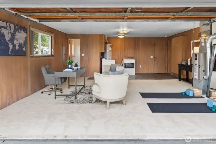 Converted garage creates a generous bonus space ideal for hobbies, fitness, or a creative studio. Built-in utility area and laundry nearby add practicality to this multi-use room.
