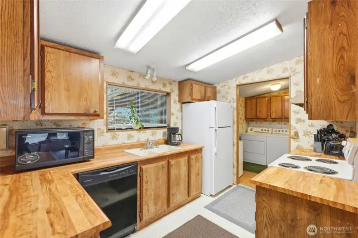 Generous kitchen featuring abundant cabinetry and expansive counter space, ideal for cooking, prep, and gathering