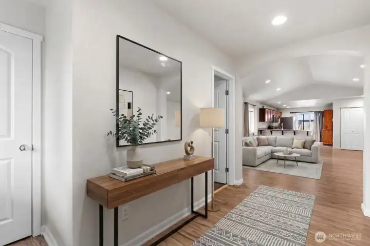 Entryway leading into main living area with open layout ( Virtually Staged )