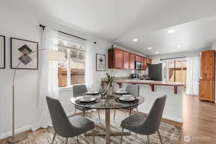 Dining area adjacent to kitchen with open flow ( Virtually Staged)