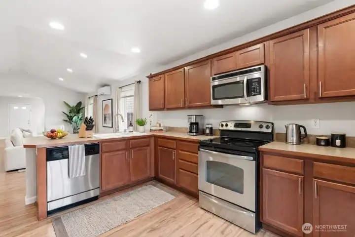 Functional kitchen layout with storage and prep space ( Virtually Staged )