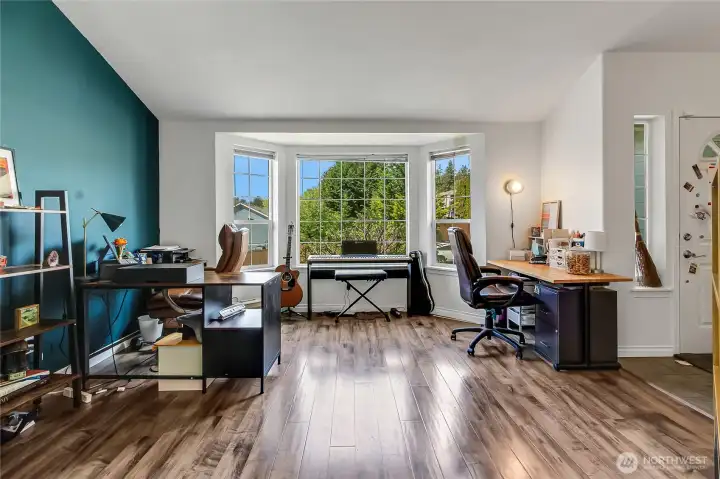 iving room with vaulted ceiling and bay-style windows; currently used as office space.