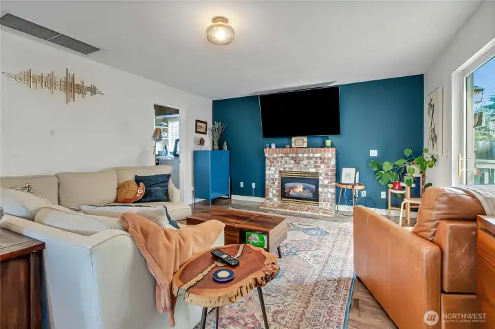 Family room with gas fireplace open to kitchen.
