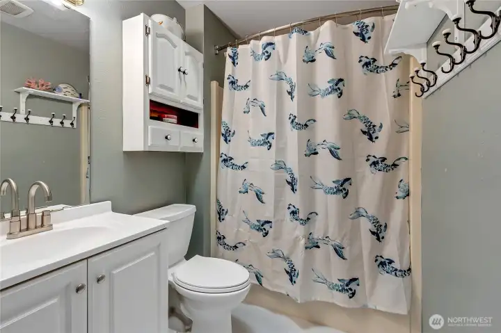 Updated hall bathroom with new vanity, fixtures, and toilet.