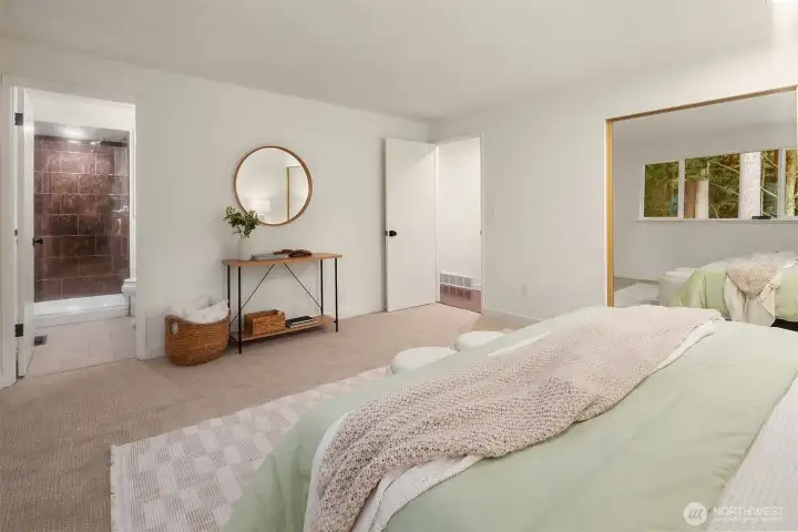 Primary suite with large mirrored closet across entire west wall.