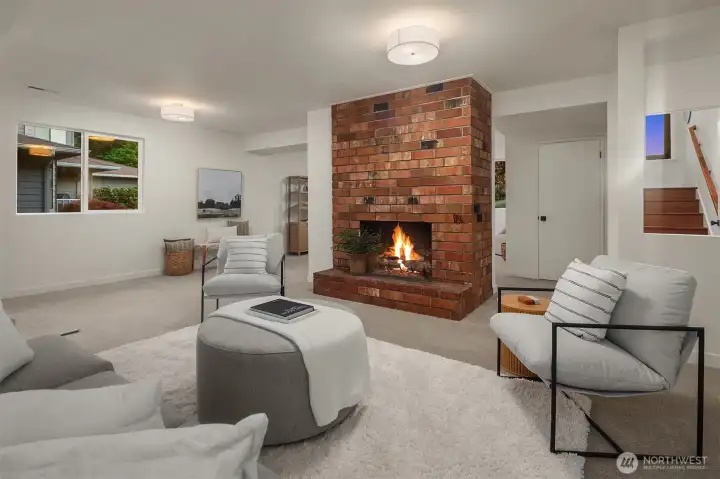 Lower rec room features high ceilings, second stacked fireplace, creating two distinct spaces.